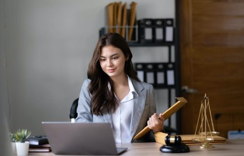 Asian lawyer woman working with a laptop computer in a law office. Legal and legal service concept.