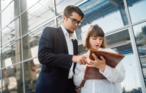 Businessman and businesswoman look at important papers